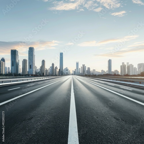 Perspective straight empty highway road with modern cityscape. Morning scene view