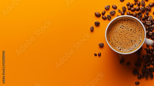 Cup of coffee and scattered beans on an orange background.