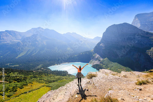 A woman looks at a mountain and lake view in Glacier National Park