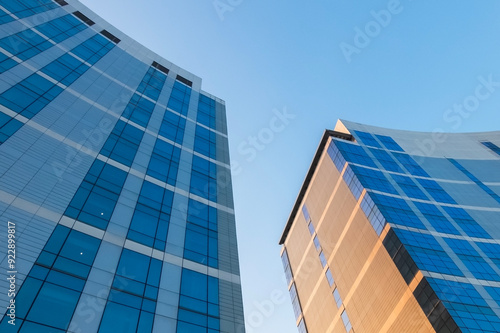 Architectural details of exterior design of skyscraper building in urban area with blue sky background. Abstract pattern of building, lines and curves. photo