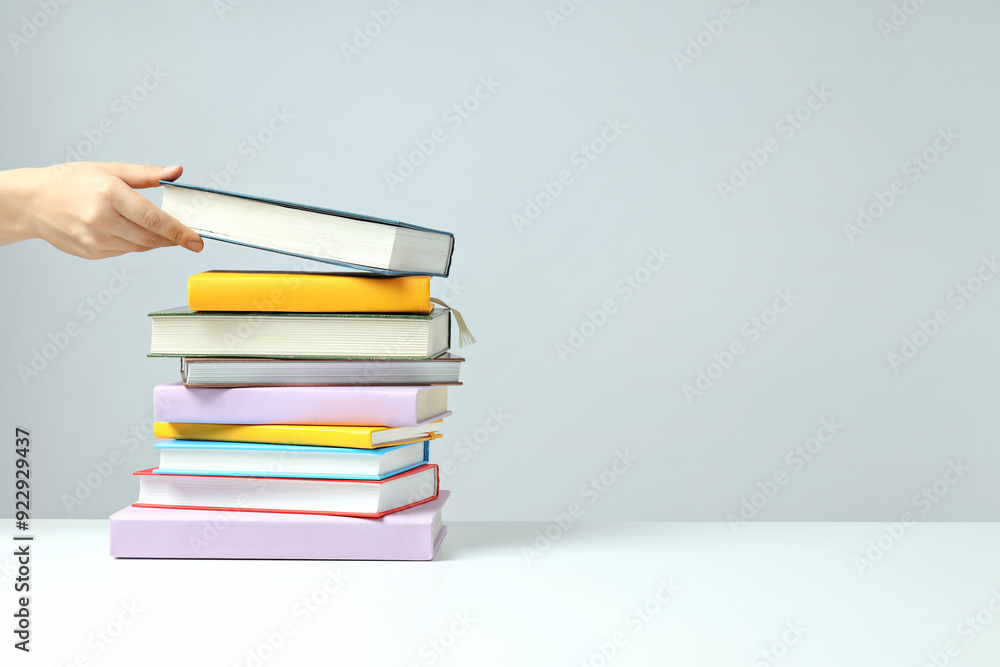 A stack of books on a light background A stack of books on a light background
