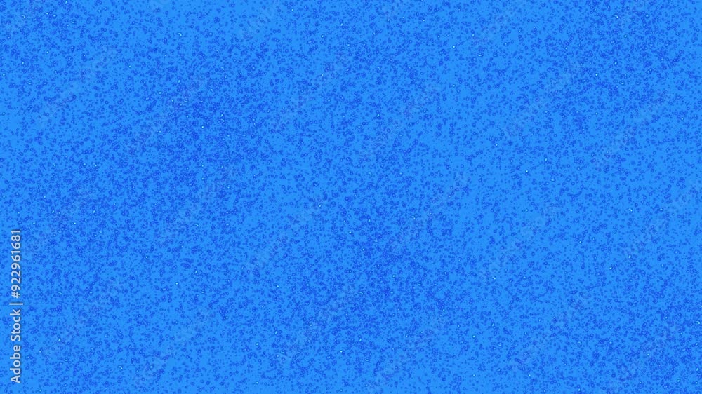 Wide blue Glitter Holiday Falling Confetti. blue dust particles flow in air on blue background Wide blue Glitter Holiday Falling Confetti. blue dust particles flow in air on blue background