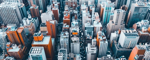 Aerial view of a dense urban cityscape with tall buildings and narrow streets. photo