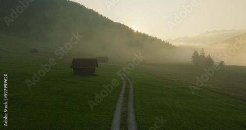 Early morning misty sunrise over country road making mysterious mood in Wagenbrüchsee, Germany, aerial view photo