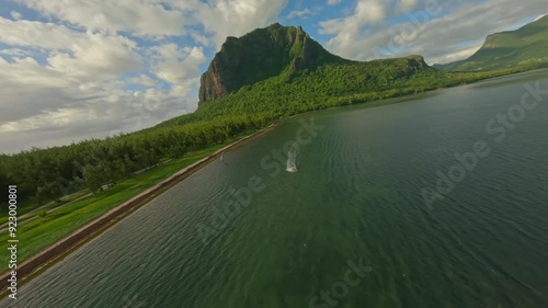Kitesurfer riding in the lagoon in front of the Le Morne Brabant landmark.