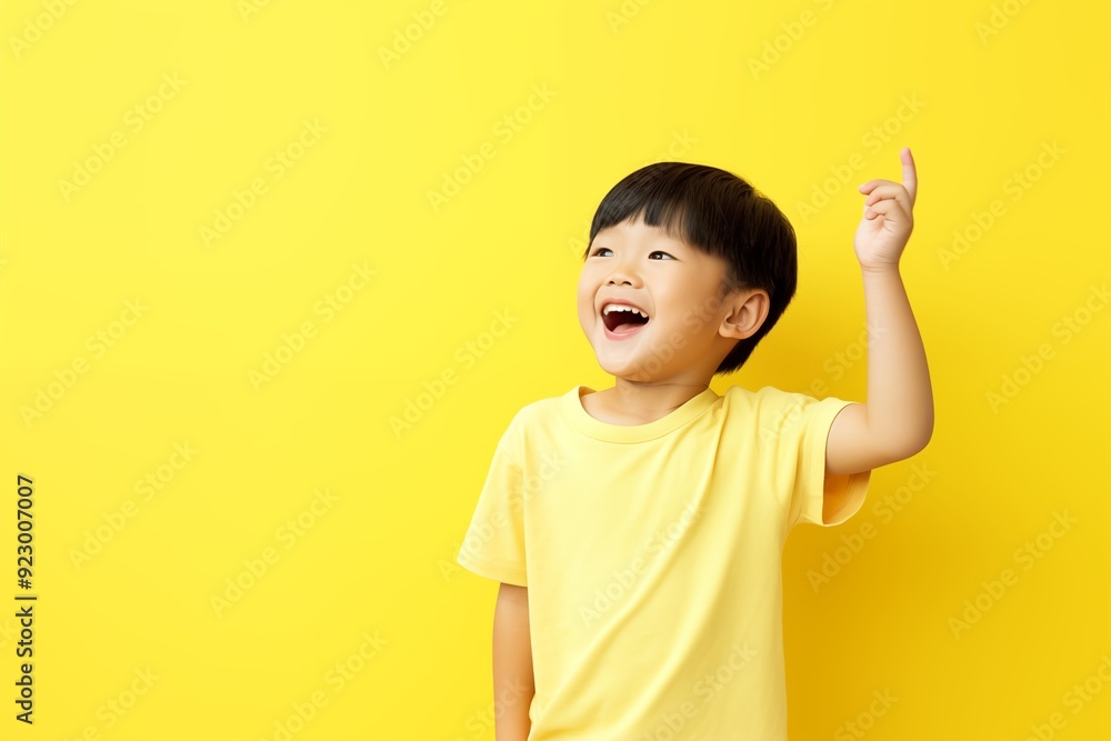 Cute little asian boy laughing and smiling raise hand Cute little asian boy laughing and smiling raise hand