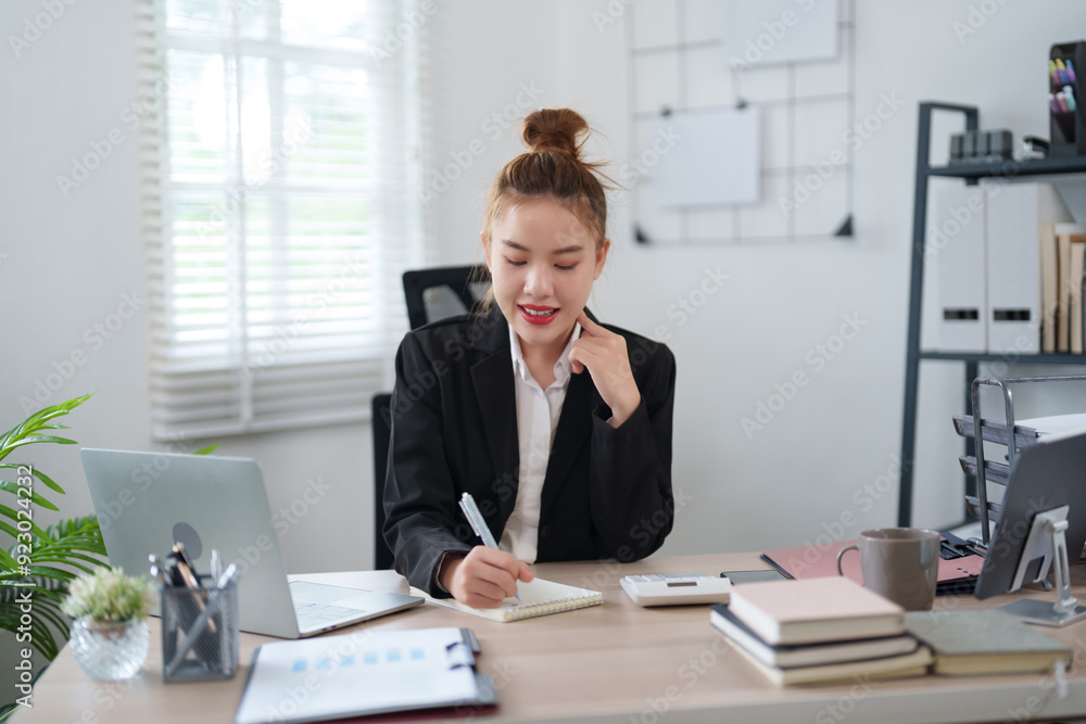 A confident businesswoman in a black suit is sitting at her desk, smiling as she engages in an online meeting, with notes and documents organized on the table in a modern office A confident businesswoman in a black suit is sitting at her desk, smiling as she engages in an online meeting, with notes and documents organized on the table in a modern office
