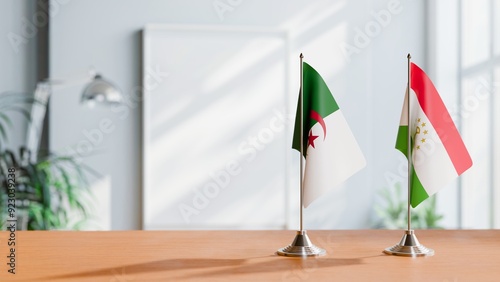 FLAGS OF ALGERIA AND TAJIKISTAN ON TABLE