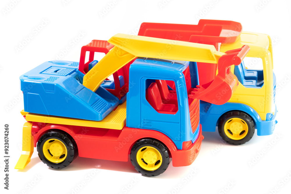Naklejka premium excavator toy.Dump truck toy isolated on white background. Construction industrial equipment for transporting materials
