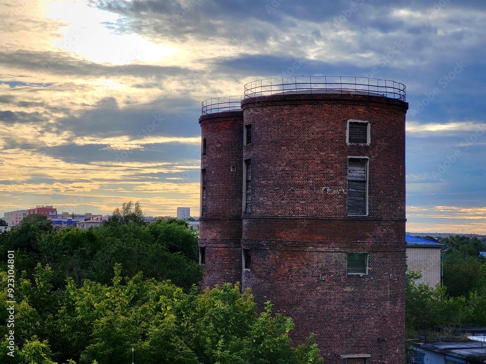 Two old abandoned brick towers on the outskirts of the city. Two old abandoned brick towers on the outskirts of the city.