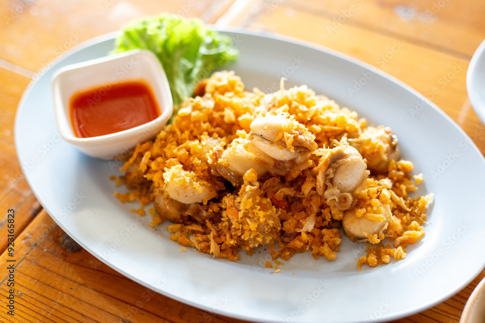 Deep-Fried tiny scallop with crispy garlics and dipping sauce. Seafood recipes popular in local street food. Deep-Fried tiny scallop with crispy garlics and dipping sauce. Seafood recipes popular in local street food.