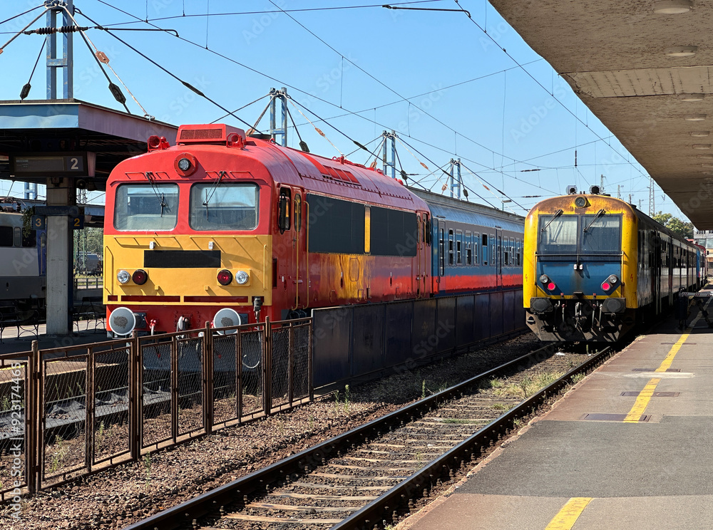 Passenger trains at the station platform Passenger trains at the station platform