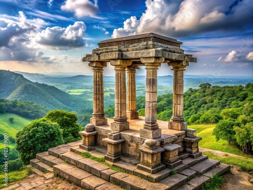 Ancient stone pedestal fortified with robust columns and intricately carved stonework, situated atop a hill, overlooking a serene landscape with lush greenery.