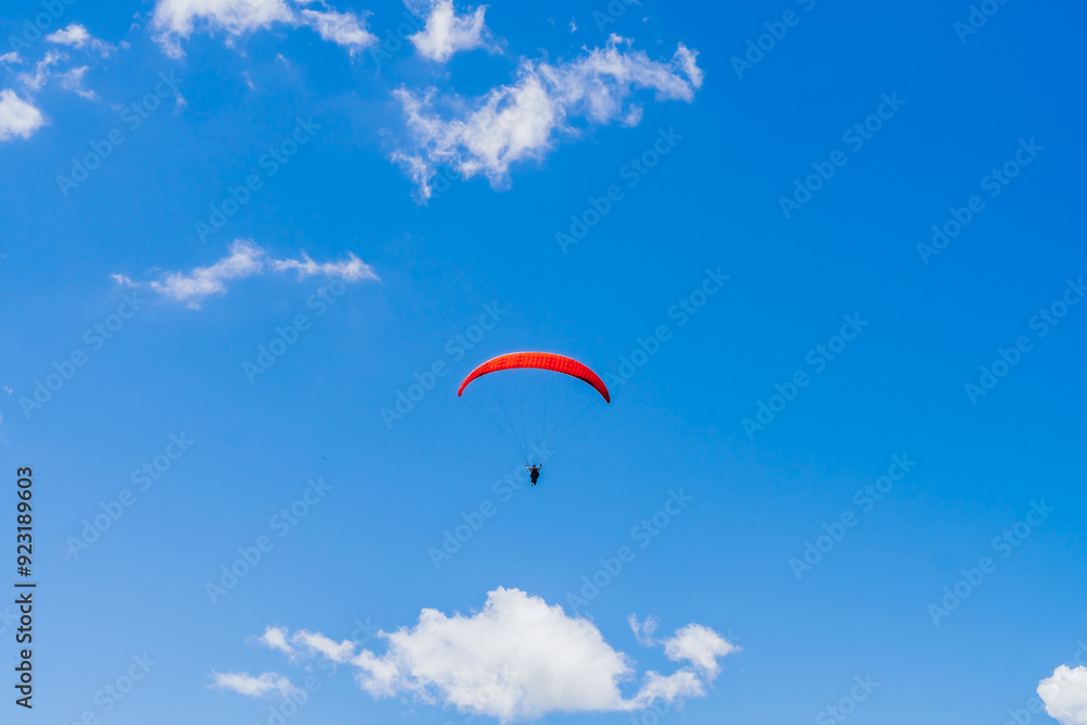 View of the sky. Person flying in a paraglider, leisure activity. Travel and landscapes. View of the sky. Person flying in a paraglider, leisure activity. Travel and landscapes.