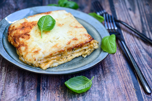  Italian Lasagna bolognese  covered with parmesan cheese  on awooden  background. photo