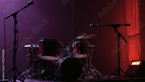  a drum set with microphones and sound equipment on a stage.