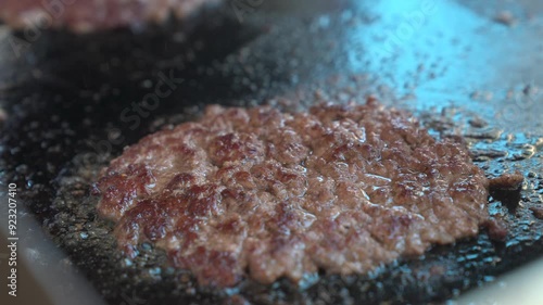 Grilling flattened hamburger patty 
