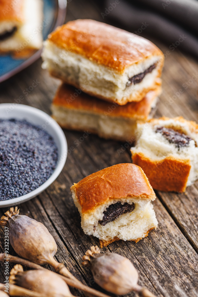 Sweet bun with poppy seed on wooden table. Sweet bun with poppy seed on wooden table.