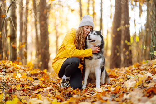 Wall Mural Woman with dogs in the park in autumn