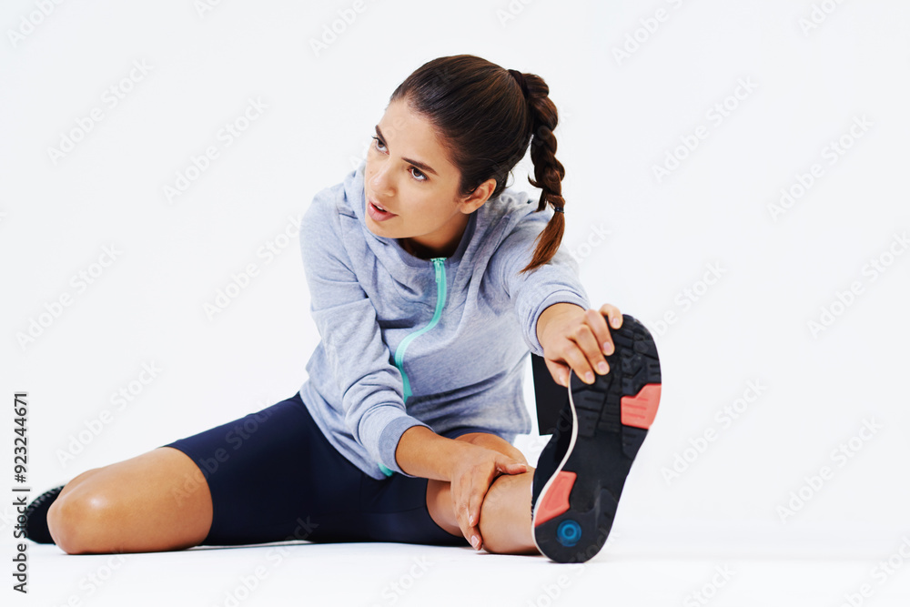 Woman, fitness and stretching with leg for workout, exercise or training on a white studio background. Young or active female person in body warm up with sneakers or sportswear for gym practice Woman, fitness and stretching with leg for workout, exercise or training on a white studio background. Young or active female person in body warm up with sneakers or sportswear for gym practice