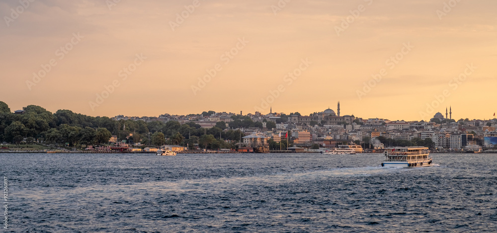 Stunning sunset view of Istanbul's coastline from the Bosphorus, with the city's Stunning sunset view of Istanbul's coastline from the Bosphorus, with the city's