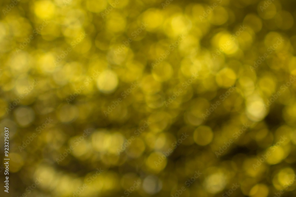 Abstract blurred yellow background with bokeh effect. Festive background. Holidays. Blurred texture. Glitter. New Year. Abstract blurred yellow background with bokeh effect. Festive background. Holidays. Blurred texture. Glitter. New Year.