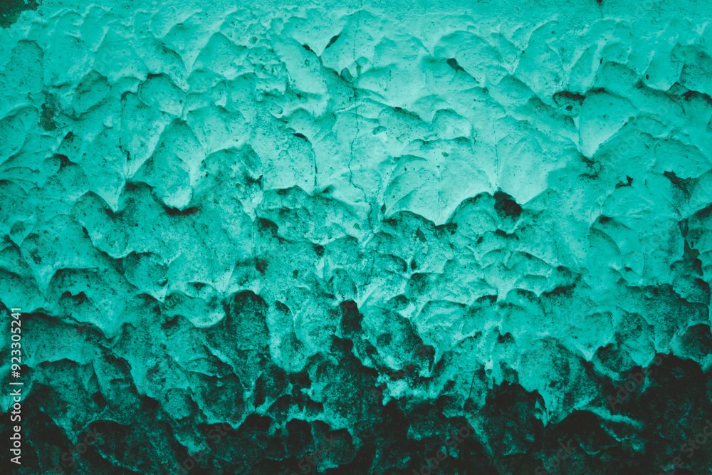 A wall with a green and blue color scheme. The wall has a textured appearance, with a mix of green and blue colors. The wall appears to be made of concrete, and it has a rough, uneven surface A wall with a green and blue color scheme. The wall has a textured appearance, with a mix of green and blue colors. The wall appears to be made of concrete, and it has a rough, uneven surface
