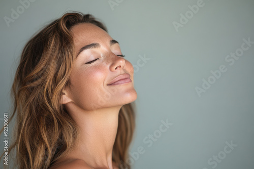 A close up of a woman's face with her eyes closed