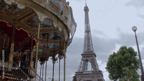The Carrousel of the Eiffel Tower in Paris starting its revolving tour. The Eifell Tower in the background. Paris, France, August 2015.