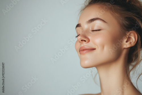 A close up of a woman's face with her eyes closed