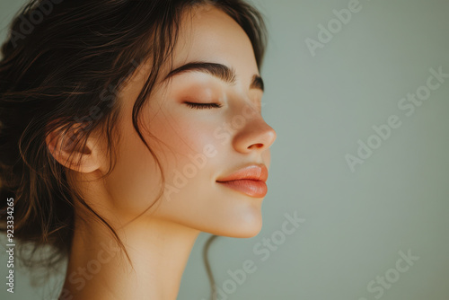 A close up of a woman's face with her eyes closed