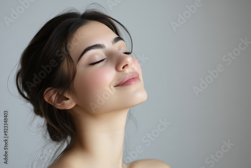 A close up of a woman's face with her eyes closed