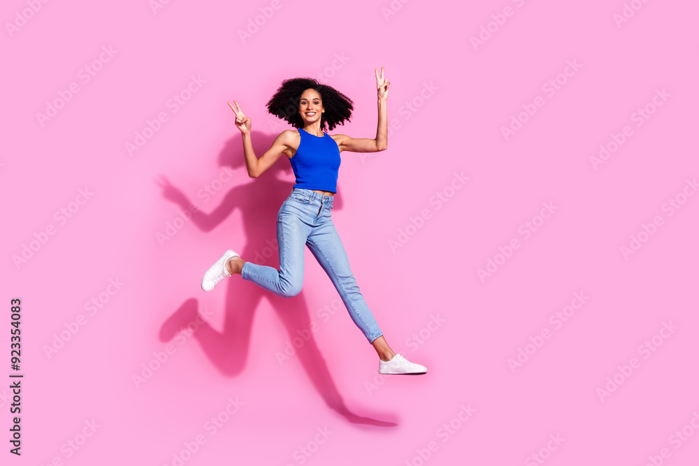 Full length photo of lovely young lady running hurry v-sign dressed stylish blue garment isolated on pink color background