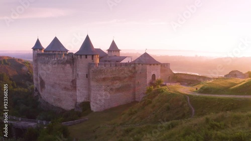 Khotyn Fortress (Ukrainian: Хотинська фортеця; Romanian: Cetatea Hotinului)  fortress of the 10th-18th centuries, huge walls towers on the banks  Dniester,  drone flies by at dawn aerial photography