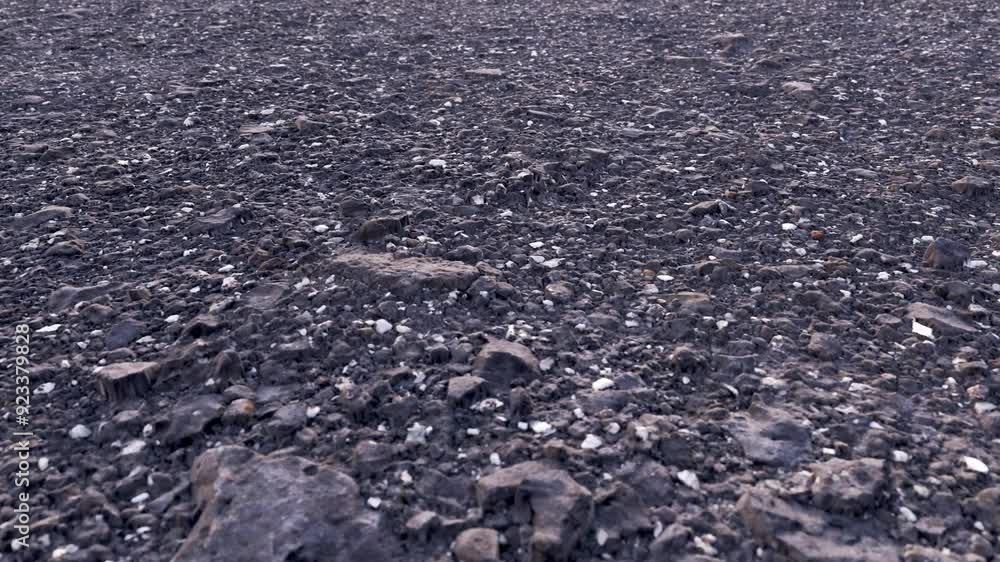 Video for updating road surfaces and asphalt. Looped detail video of a city road under construction. Dark texture with crushed stone close-up. Video for updating road surfaces and asphalt. Looped detail video of a city road under construction. Dark texture with crushed stone close-up.