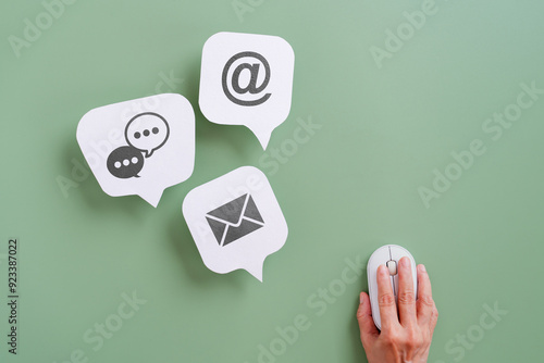 real white grunge speech bubble paper cut with contact us sign  and hand using wireless mouse for online customer service, feedback, frequently asked question