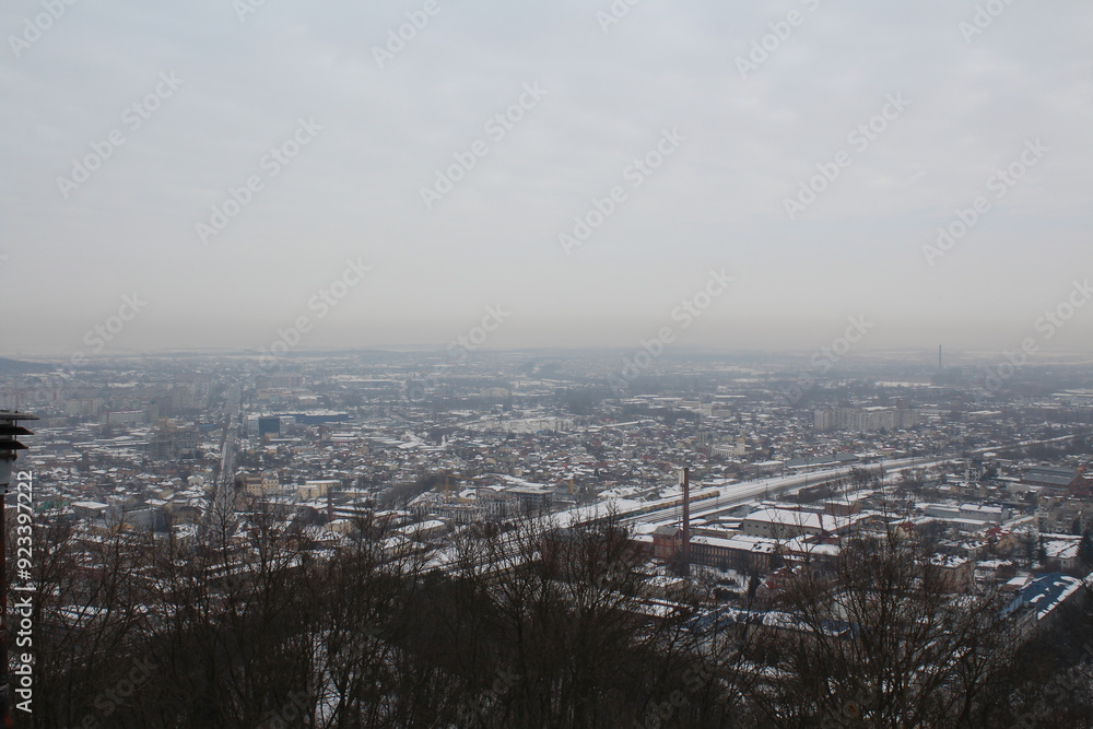Old town in Lviv, winter view from the top of the mountain on the snow-covered lions in the fog Old town in Lviv, winter view from the top of the mountain on the snow-covered lions in the fog