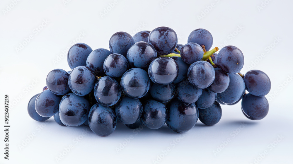Bunch of deep purple grapes against a pristine white backdrop. Bunch of deep purple grapes against a pristine white backdrop.