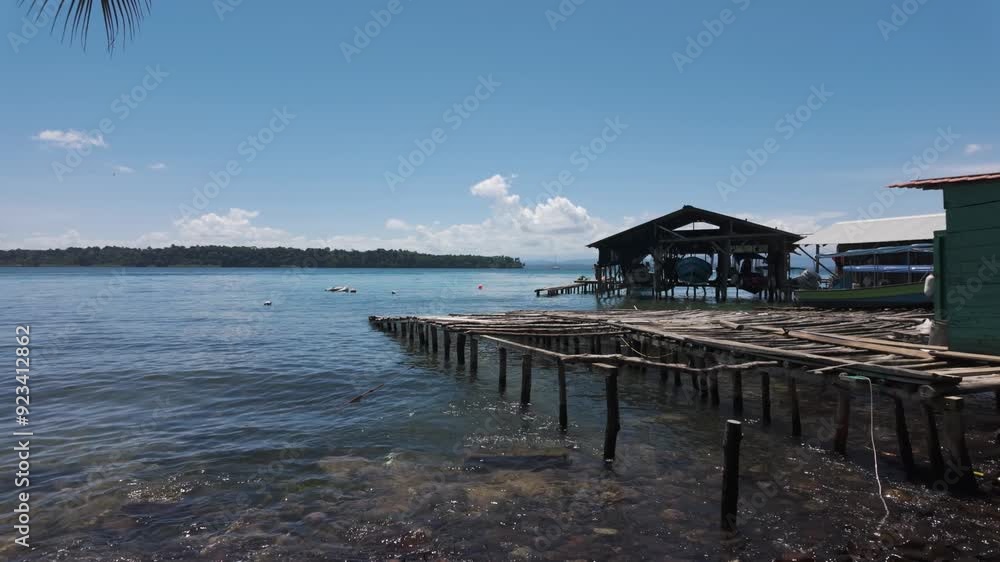 Rustic dock over calm waters on Bastimentos Island, Panama, under a bright blue sky Rustic dock over calm waters on Bastimentos Island, Panama, under a bright blue sky