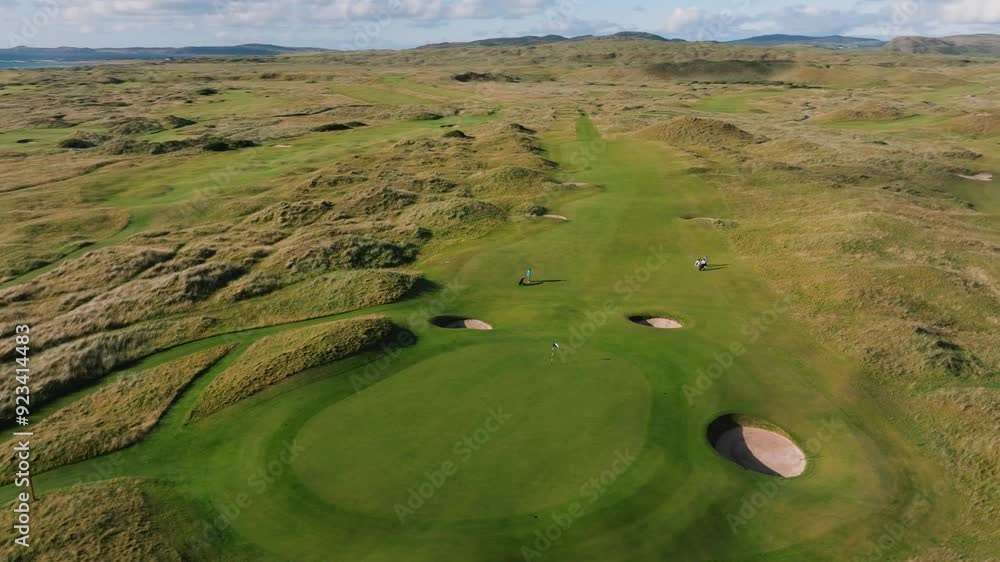 Drone orbits over putting green on Ireland links golf course along coast Drone orbits over putting green on Ireland links golf course along coast