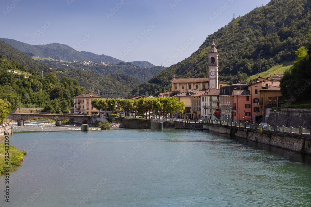 View of the beautiful spa town of San Pellegrino Terme and the Brembo river, in the Province of Bergamo, Italy. Copy space below. View of the beautiful spa town of San Pellegrino Terme and the Brembo river, in the Province of Bergamo, Italy. Copy space below.