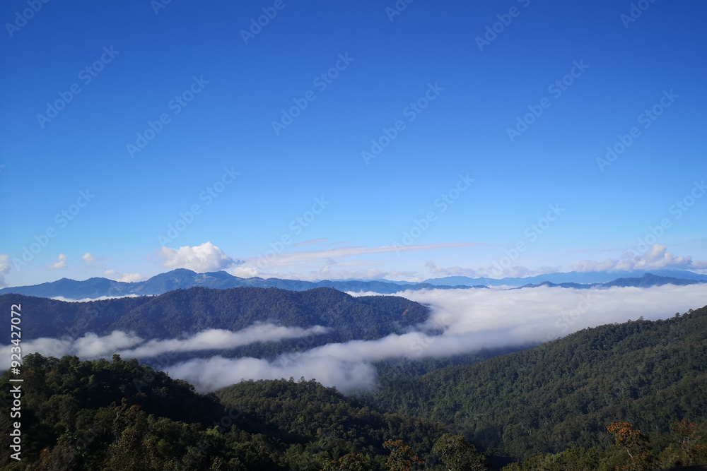 Summer mountain landscape with green meadows, and a panoramic sky filled with clouds Summer mountain landscape with green meadows, and a panoramic sky filled with clouds