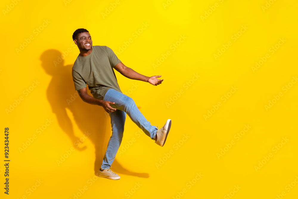 Photo of cheerful glad nice man wear trendy khaki clothes look empty space isolated on yellow color background Photo of cheerful glad nice man wear trendy khaki clothes look empty space isolated on yellow color background