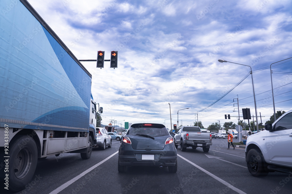 Obraz premium Rush hour cars, city roads, cars on the highway in traffic jam, waiting at traffic lights