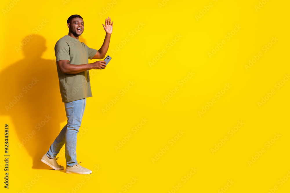 Fototapeta premium Photo of cheerful nice attractive man wear trendy khaki clothes store mall empty space isolated on yellow color background