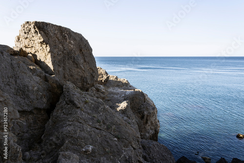 sea bay at the foot of the mountains against the blue sky on a summer day landscape