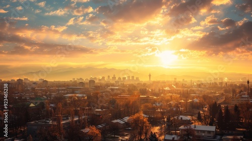 A stunning city skyline at sunrise with golden clouds illuminating the buildings and mountains in the background, capturing the essence of a new beginning and hope.