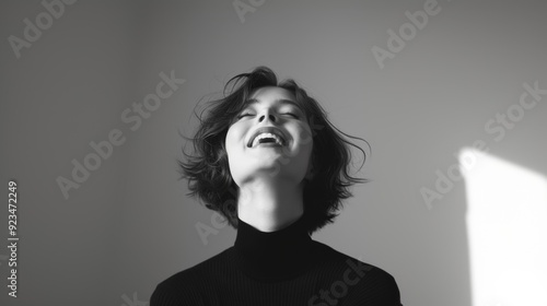 Expressive portrait: Black and white photo of brunette woman, with an expression of happiness, joy, excitement.