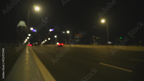 Blurred lights bokeh car & bus headlights driving night city road with audio. Defocused road traffic transport at big city at night time. Lights from headlights, streetlights and clearance lights. photo