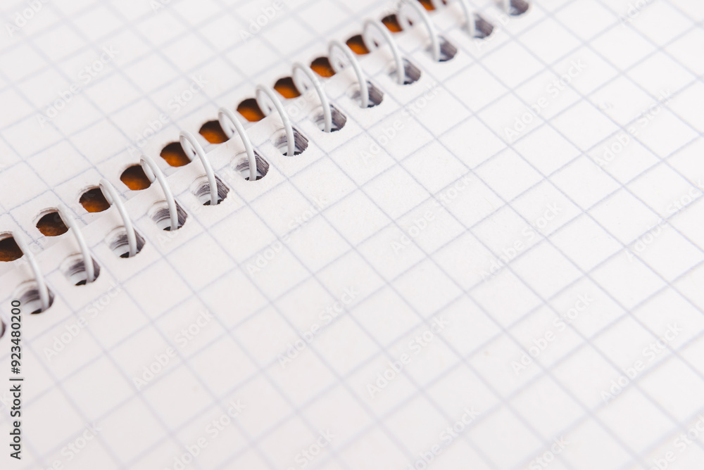 A detail of a notepad of squared paper. Close-up. A detail of a notepad of squared paper. Close-up.